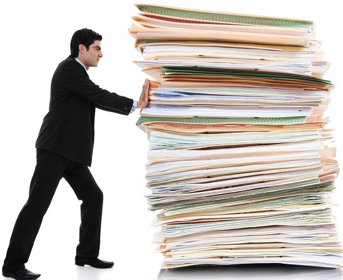 Guy Pushing Stack of Papers Guy Pushing Stack of Papers